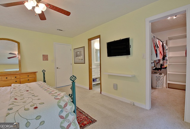 210 Grandchester Way, Fayetteville, GA 30215 - bedroom with light colored carpet, a spacious closet, a closet, ceiling fan, and ensuite bath