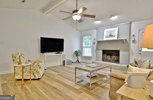 210 Grandchester Way, Fayetteville, GA 30215 - living room featuring light wood-style floors, a fireplace, ceiling fan, and a textured ceiling