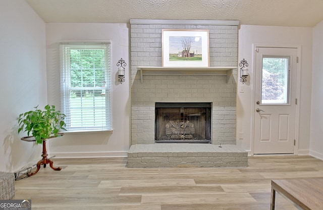 210 Grandchester Way, Fayetteville, GA 30215 - living room with wood finished floors, a fireplace, healthy amount of natural light, and a textured ceiling