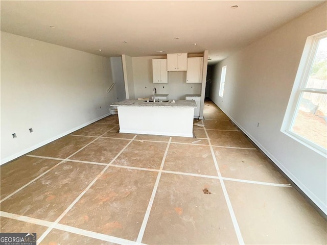 11594 E Lovejoy Rd Unit 1, Hampton, GA 30228 - kitchen featuring white cabinetry, a center island with sink, and light tile patterned floors