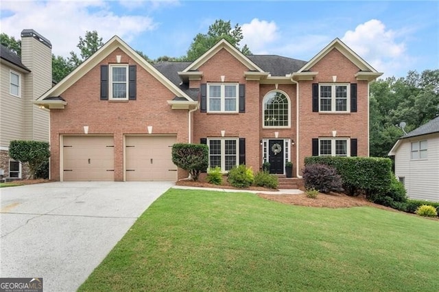 2772 Hillgrove Dr, Dacula, GA 30019 - colonial inspired home featuring brick siding, a front yard, and an attached garage