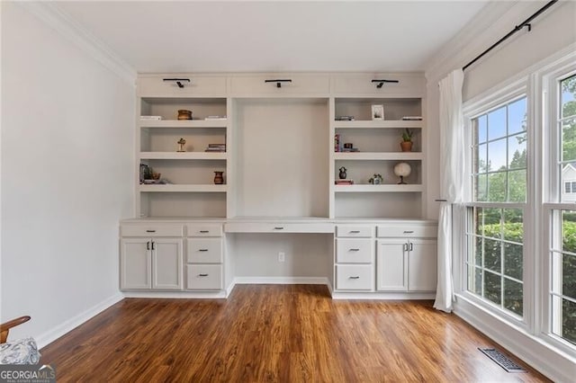 2772 Hillgrove Dr, Dacula, GA 30019 - unfurnished office featuring wood finished floors, built in desk, and crown molding