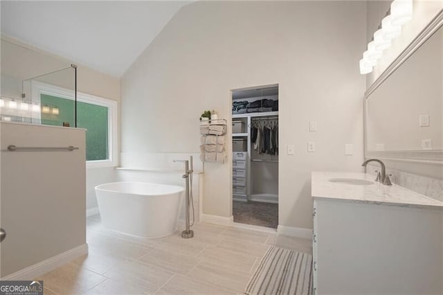 2772 Hillgrove Dr, Dacula, GA 30019 - bathroom with vanity, a freestanding tub, a spacious closet, tile patterned floors, and a shower
