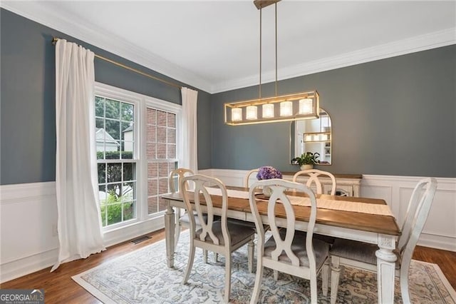 2772 Hillgrove Dr, Dacula, GA 30019 - dining room featuring ornamental molding, healthy amount of natural light, wainscoting, wood finished floors, and a decorative wall