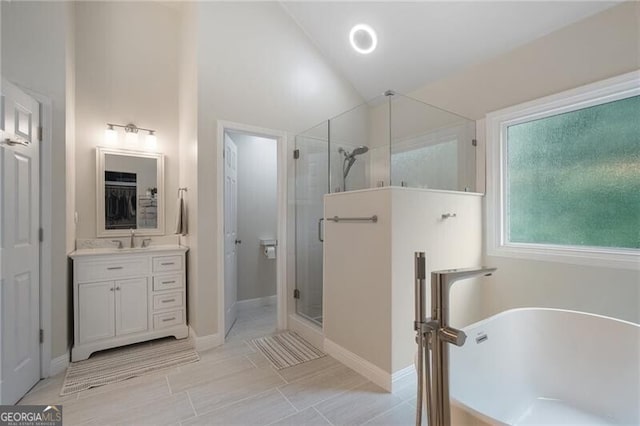2772 Hillgrove Dr, Dacula, GA 30019 - bathroom with a stall shower, a freestanding bath, vanity, and lofted ceiling