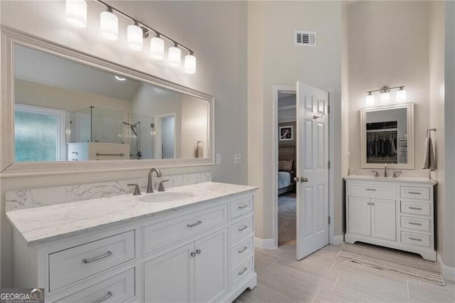 2772 Hillgrove Dr, Dacula, GA 30019 - full bathroom with two vanities, a stall shower, and ensuite bath
