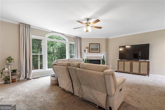 2772 Hillgrove Dr, Dacula, GA 30019 - living area featuring carpet, ceiling fan, a fireplace, and ornamental molding