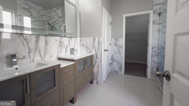 3368 Alhambra Cir, Hampton, GA 30228 - bathroom with a marble finish shower, tile walls, vanity, a spacious closet, and a wainscoted wall