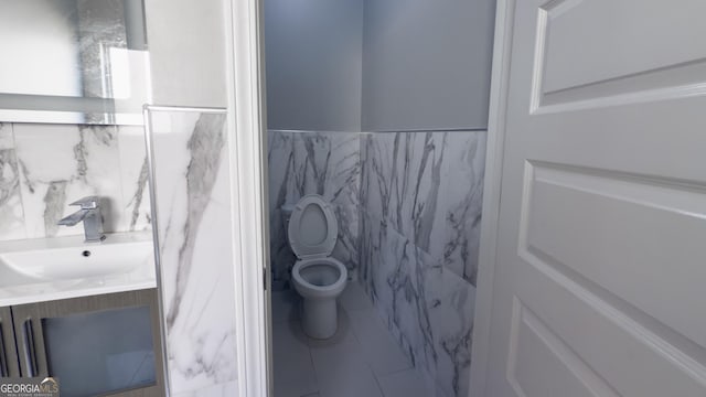 3368 Alhambra Cir, Hampton, GA 30228 - bathroom with tile walls, vanity, tile patterned flooring, and a wainscoted wall
