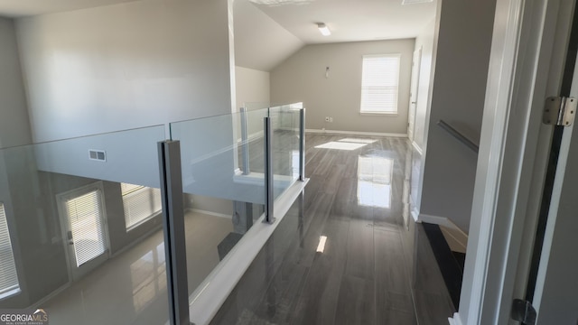 3368 Alhambra Cir, Hampton, GA 30228 - hall with an upstairs landing, dark wood-style flooring, and lofted ceiling