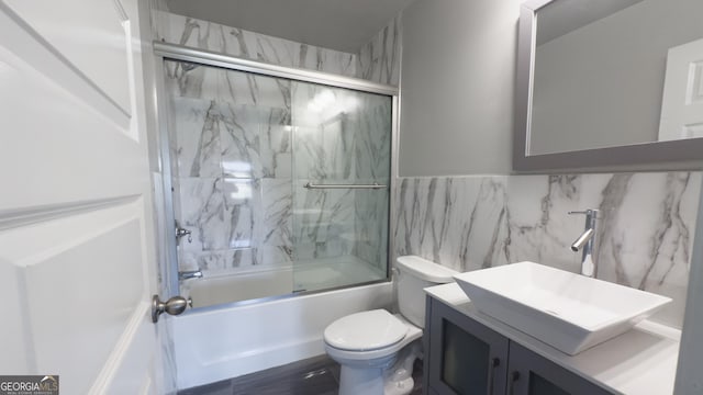 3368 Alhambra Cir, Hampton, GA 30228 - full bathroom with vanity, bath / shower combo with glass door, and tile walls