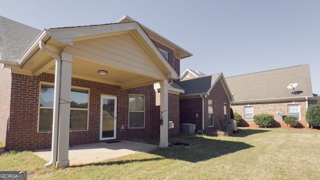 3368 Alhambra Cir, Hampton, GA 30228 - back of property with brick siding, a yard, a patio area, and roof with shingles