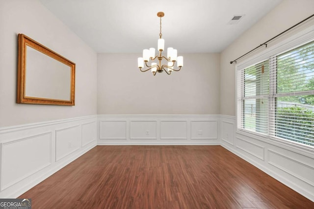255 Hamilton Dr, Newnan, GA 30263 - spare room with a chandelier, wood finished floors, a wainscoted wall, and a decorative wall