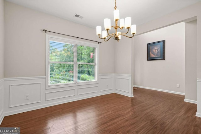 255 Hamilton Dr, Newnan, GA 30263 - empty room with a chandelier, wainscoting, wood finished floors, and a decorative wall