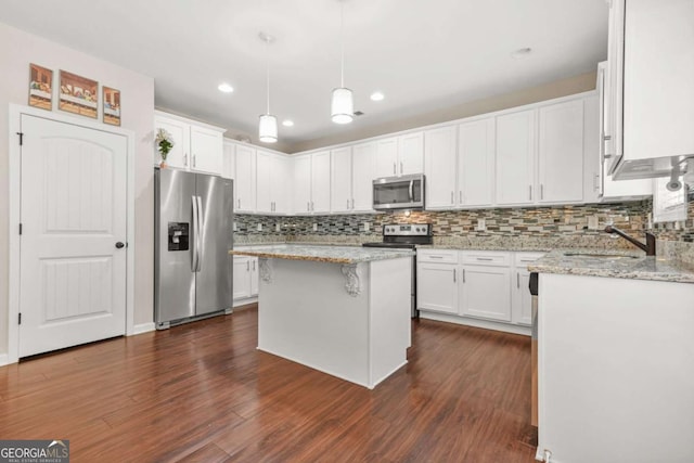 255 Hamilton Dr, Newnan, GA 30263 - kitchen with appliances with stainless steel finishes, white cabinetry, tasteful backsplash, dark wood finished floors, and recessed lighting