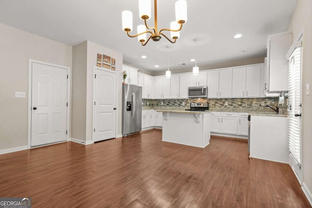 255 Hamilton Dr, Newnan, GA 30263 - kitchen featuring appliances with stainless steel finishes, white cabinetry, decorative backsplash, a chandelier, and recessed lighting