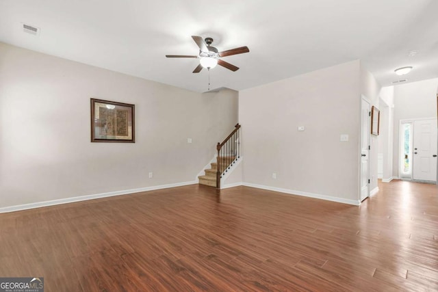 255 Hamilton Dr, Newnan, GA 30263 - unfurnished living room featuring ceiling fan, stairs, and wood finished floors