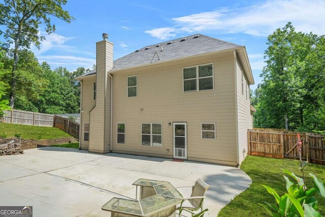 255 Hamilton Dr, Newnan, GA 30263 - back of house featuring a fenced backyard, a patio, and a chimney