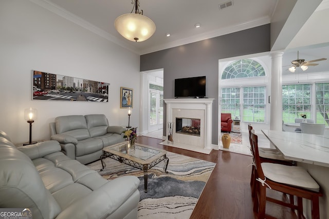 1000 Collingtree Ct, Mcdonough, GA 30253 - living room featuring plenty of natural light, crown molding, dark wood-style flooring, a high end fireplace, and ornate columns