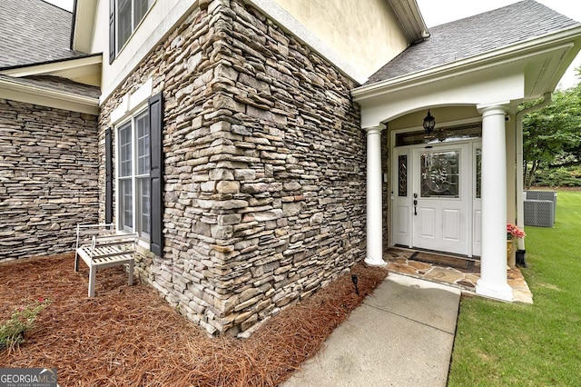 1000 Collingtree Ct, Mcdonough, GA 30253 - view of exterior entry with stone siding, a shingled roof, and a yard