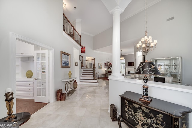 1000 Collingtree Ct, Mcdonough, GA 30253 - entryway with decorative columns, a high ceiling, stairs, ornamental molding, and a chandelier