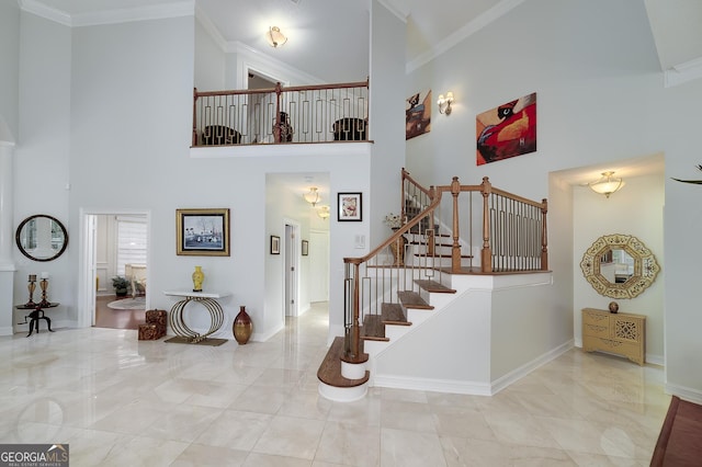 1000 Collingtree Ct, Mcdonough, GA 30253 - staircase featuring a towering ceiling and ornamental molding
