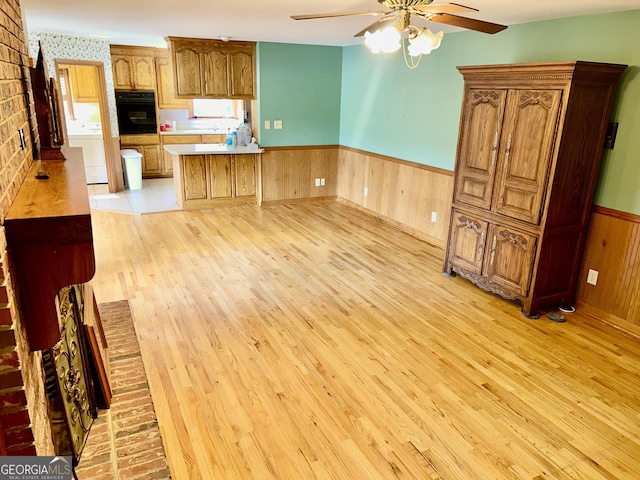 4494 Anderson Hwy, Hartwell, GA 30643 - kitchen with oven, a wainscoted wall, light wood finished floors, ceiling fan, and a peninsula