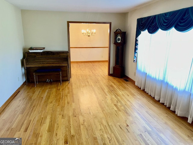 4494 Anderson Hwy, Hartwell, GA 30643 - spare room featuring a chandelier and light wood-style flooring