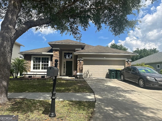 5785 Alamosa Cir, Jacksonville, FL 32258 - view of front of property featuring stone siding, an attached garage, driveway, and a front lawn