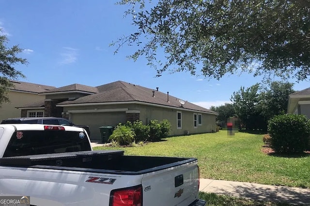 5785 Alamosa Cir, Jacksonville, FL 32258 - view of side of home featuring a garage and a yard
