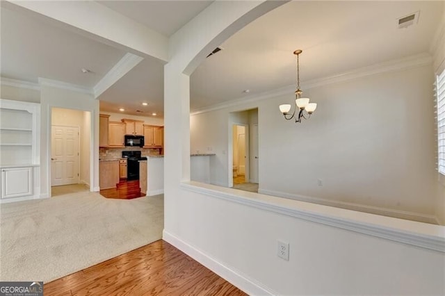 3411 Lindenridge Dr, Buford, GA 30519 - unfurnished dining area with arched walkways, crown molding, a chandelier, recessed lighting, and light wood-style floors