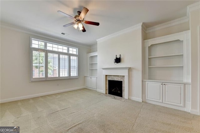 3411 Lindenridge Dr, Buford, GA 30519 - unfurnished living room with crown molding, ceiling fan, light carpet, a tile fireplace, and built in features