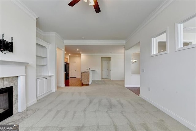 3411 Lindenridge Dr, Buford, GA 30519 - unfurnished living room featuring ceiling fan, ornamental molding, a tile fireplace, light carpet, and built in shelves