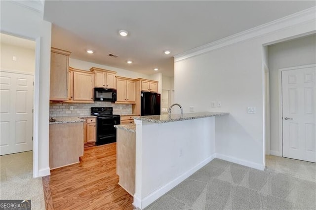 3411 Lindenridge Dr, Buford, GA 30519 - kitchen with black appliances, a peninsula, decorative backsplash, light brown cabinets, and light stone countertops