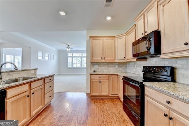 3411 Lindenridge Dr, Buford, GA 30519 - kitchen featuring black appliances, light brown cabinets, light wood-type flooring, light stone countertops, and decorative backsplash