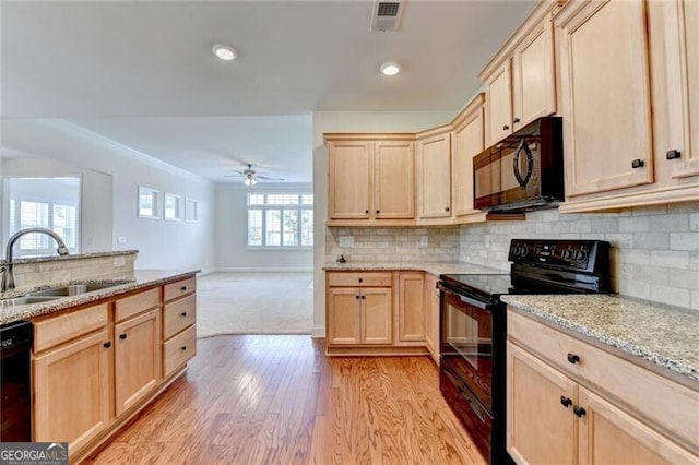 3411 Lindenridge Dr, Buford, GA 30519 - kitchen featuring black appliances, light brown cabinets, light wood-type flooring, a ceiling fan, and light stone countertops