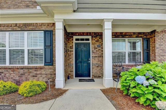 3411 Lindenridge Dr, Buford, GA 30519 - view of exterior entry with brick siding and a porch