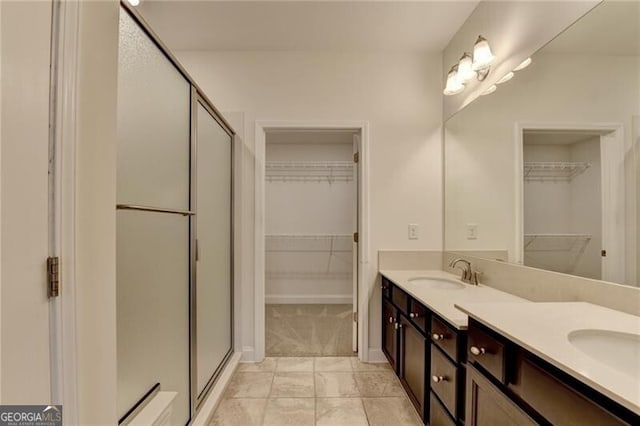 3411 Lindenridge Dr, Buford, GA 30519 - bathroom with a shower stall, double vanity, and a spacious closet
