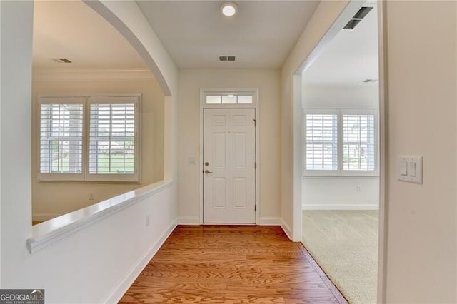 3411 Lindenridge Dr, Buford, GA 30519 - entryway with arched walkways, healthy amount of natural light, wood finished floors, and crown molding