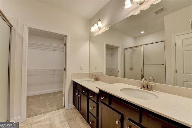 3411 Lindenridge Dr, Buford, GA 30519 - bathroom with a shower stall, double vanity, and a walk in closet