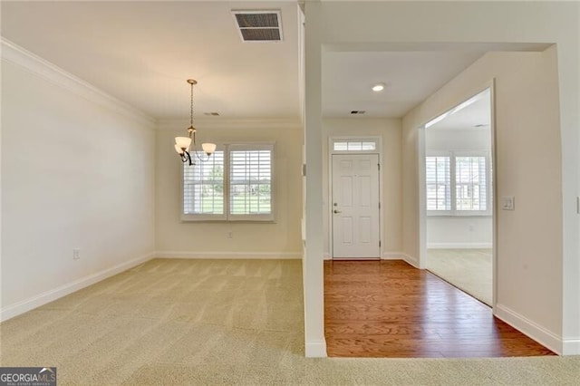 3411 Lindenridge Dr, Buford, GA 30519 - entrance foyer featuring a chandelier, crown molding, carpet floors, and wood finished floors