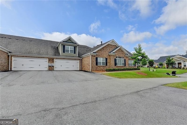 3411 Lindenridge Dr, Buford, GA 30519 - view of front facade featuring driveway, a front yard, brick siding, and a garage