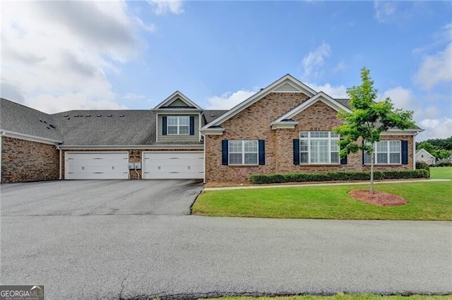 3411 Lindenridge Dr, Buford, GA 30519 - view of front of property with asphalt driveway, a front yard, and brick siding