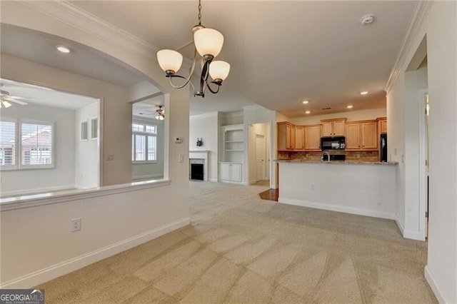 3411 Lindenridge Dr, Buford, GA 30519 - unfurnished living room featuring ceiling fan, crown molding, light colored carpet, a chandelier, and a fireplace