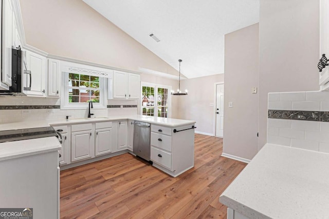 4210 Platinum Ct, Hoschton, GA 30548 - kitchen with dishwasher, a peninsula, light wood-style flooring, high vaulted ceiling, and white cabinetry
