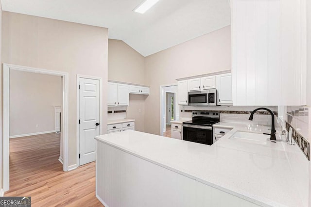 4210 Platinum Ct, Hoschton, GA 30548 - kitchen featuring appliances with stainless steel finishes, tasteful backsplash, high vaulted ceiling, light countertops, and a peninsula