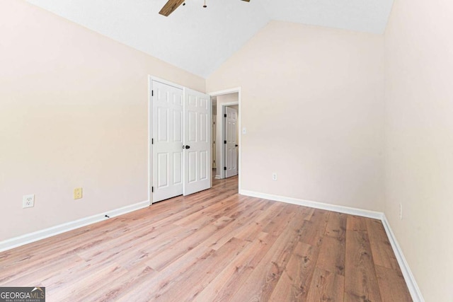 4210 Platinum Ct, Hoschton, GA 30548 - unfurnished bedroom with light wood finished floors, lofted ceiling, and ceiling fan