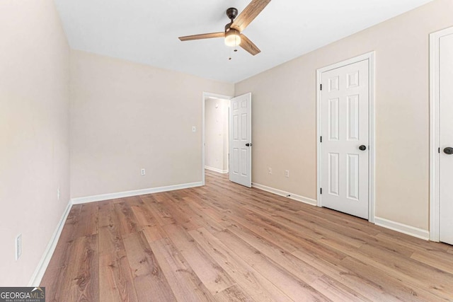 4210 Platinum Ct, Hoschton, GA 30548 - unfurnished bedroom featuring light wood-style floors and a ceiling fan