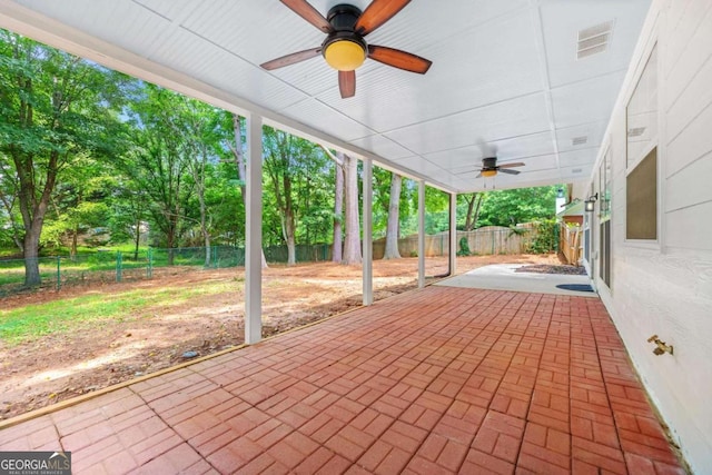 4210 Platinum Ct, Hoschton, GA 30548 - fenced backyard featuring ceiling fan, a patio area, and view of wooded area