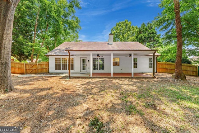 4210 Platinum Ct, Hoschton, GA 30548 - rear view of property featuring a ceiling fan, a chimney, and a patio area